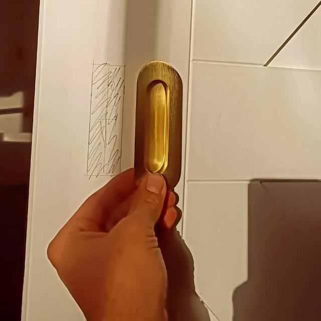 Recessed brass pull on a barn door