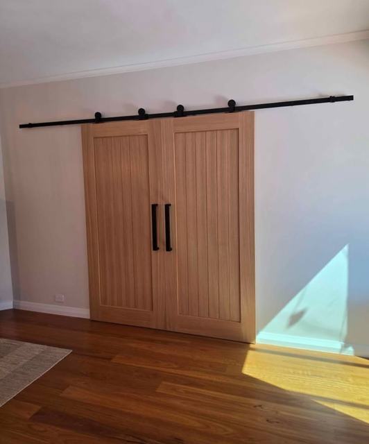Double timber barn doors on a black track