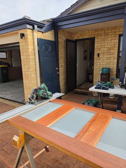 Glass-panel door prepared on sawhorses