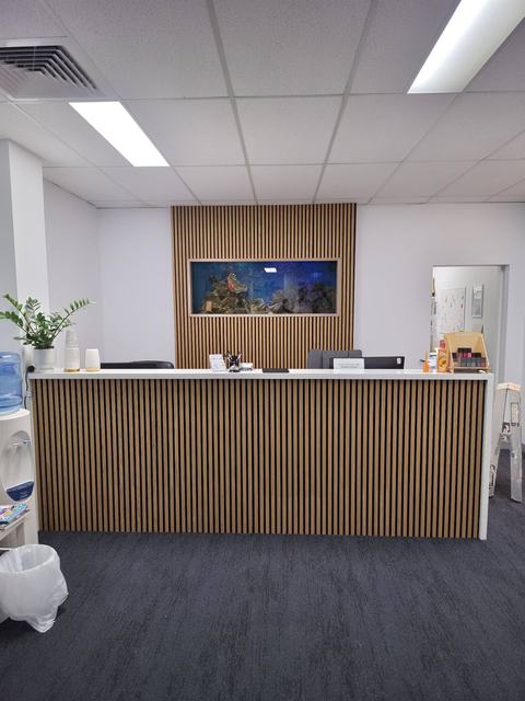 Reception counter clad in timber battens
