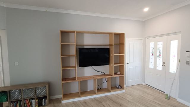 Built-in shelving wall around the TV