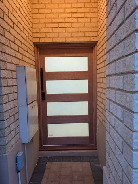 Timber entry door with frosted glass panels