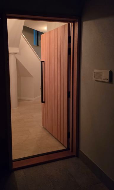 Tall timber front door at night
