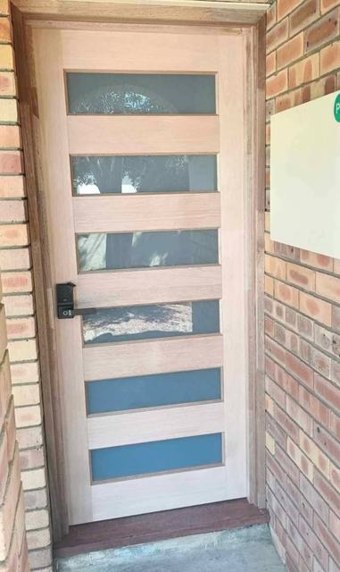 Timber entry door with frosted glass strips