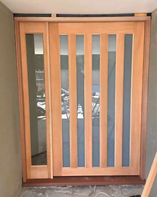 Timber entry door with vertical glass and side light