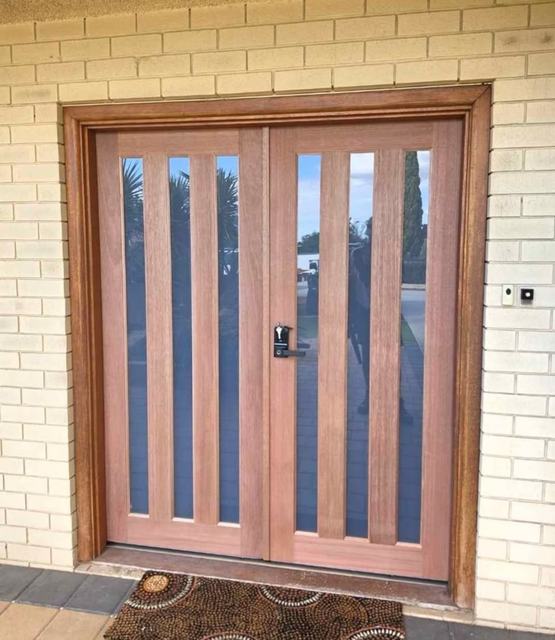 Timber double entry doors with vertical glass