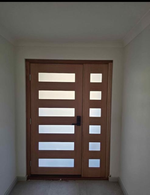 Dark timber double doors with frosted glass