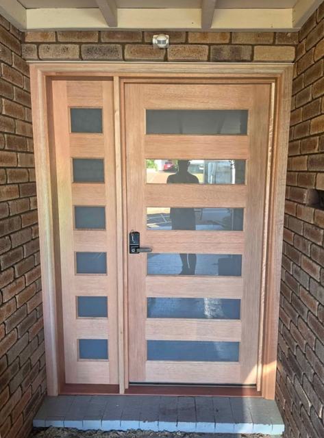 Timber entry door and side panel with glass slots