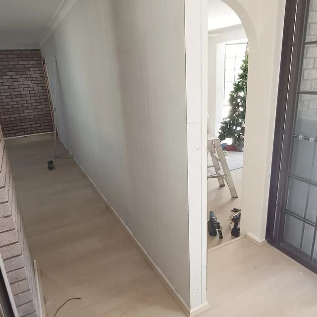 Hallway wall sheeted and finished