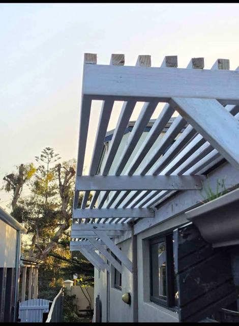 White timber pergola with slatted roof