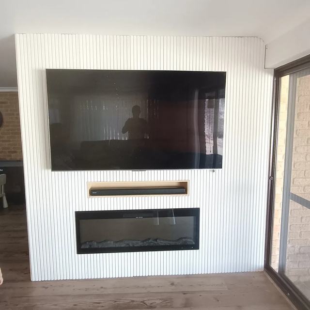 Finished TV and fireplace feature wall