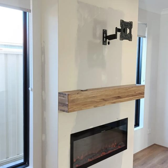 Fireplace and TV wall with timber mantel
